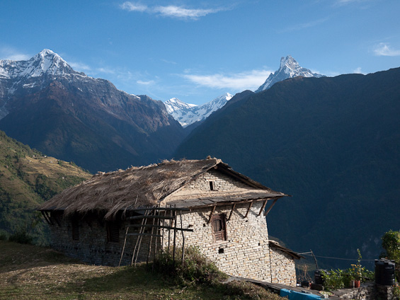 A barn on the Nepalese mountainside with Annapurna in the background.