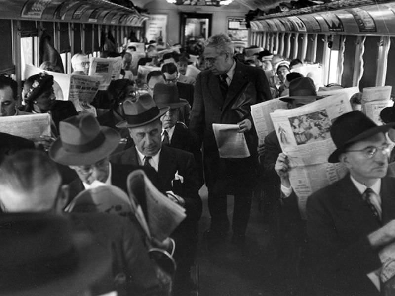staring at newspapers on a train