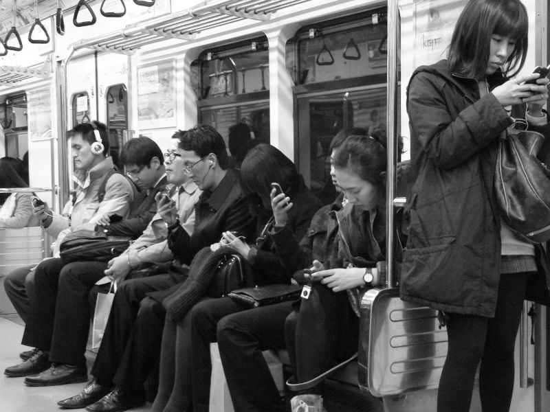 staring at smartphones on a train