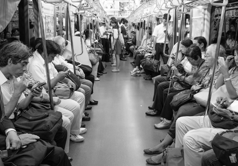 staring at smartphones on a train