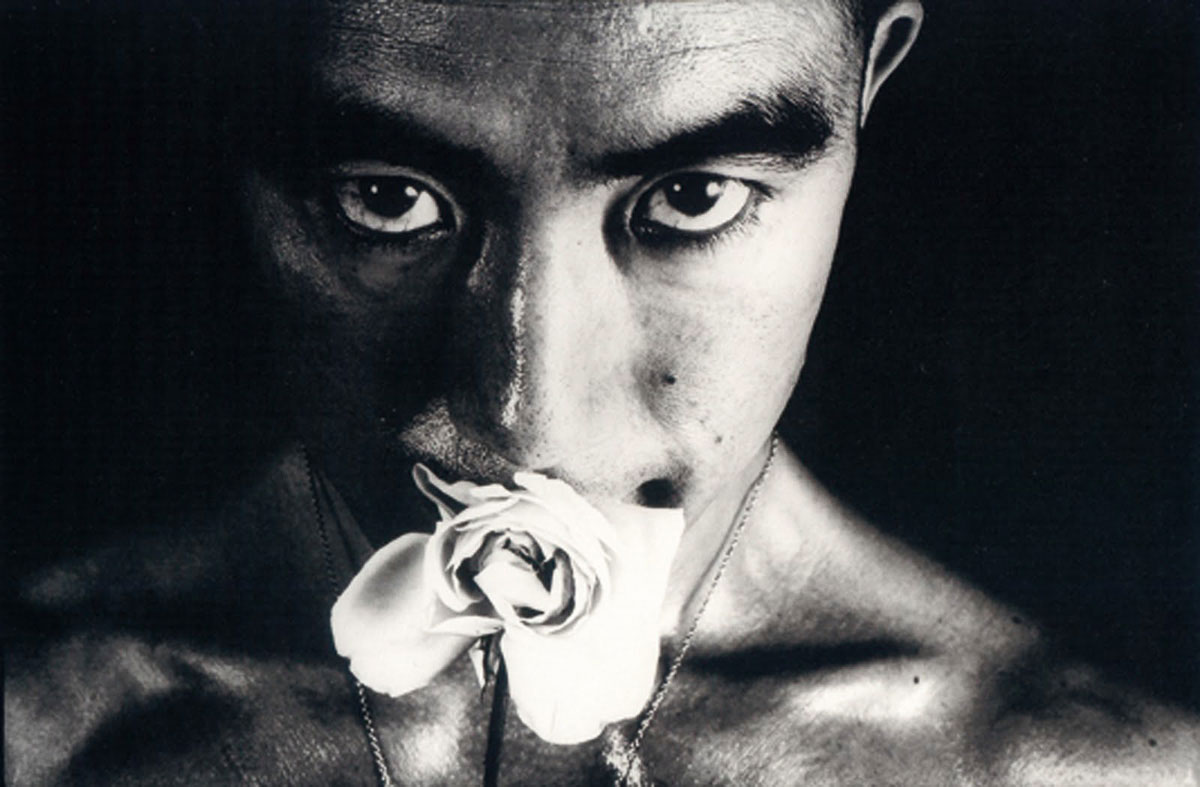 Mishima, as shot by Hosoe, rose in mouth