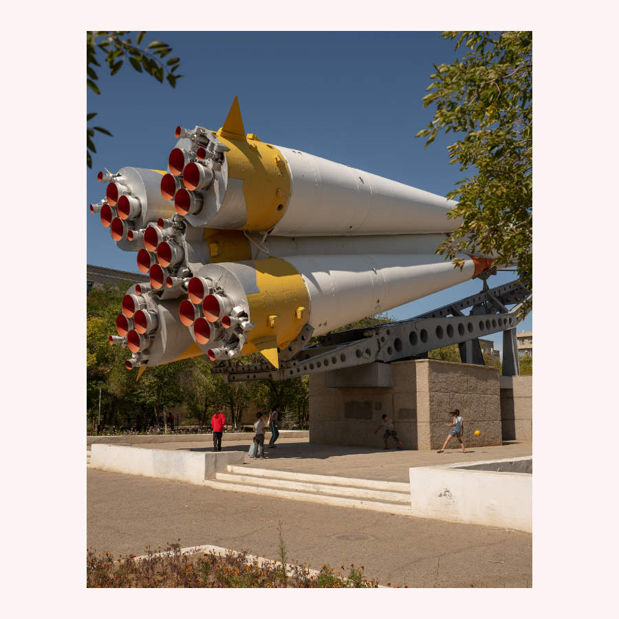 Children playing under rocket