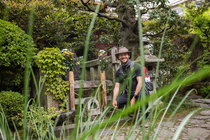 Craig, squating in front of Matsuo Basho's grave, like a big freggin dork